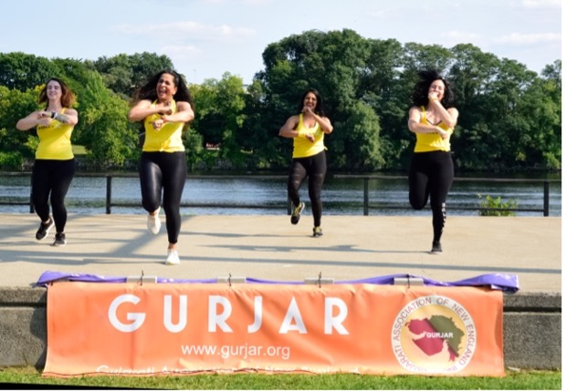 A group of women running on a track    Description automatically generated with medium confidence