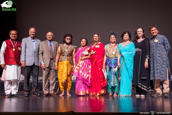 A group of people standing on a stage    Description automatically generated